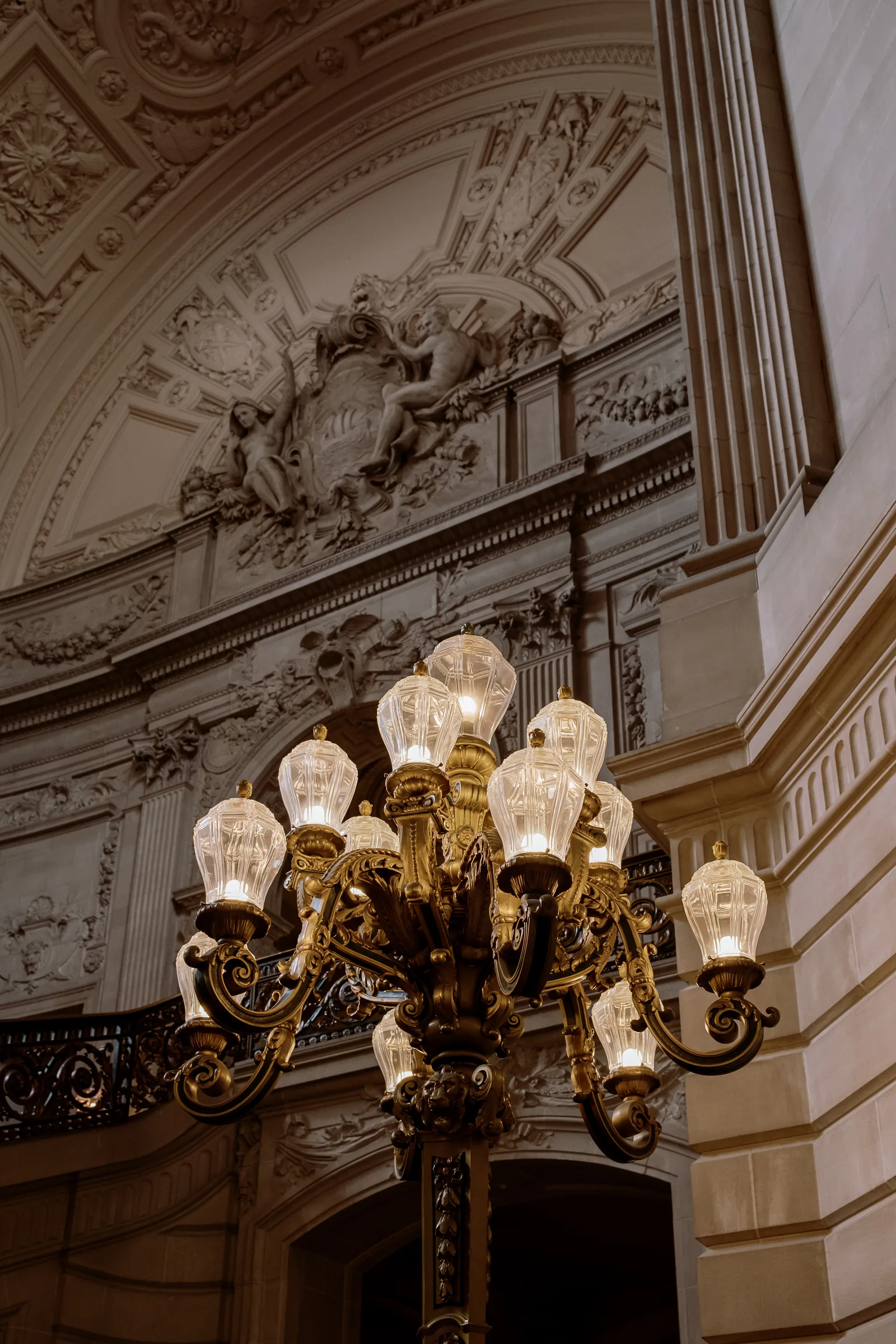 Gilded chandelier and carved plaster arch in a grand San Francisco interior