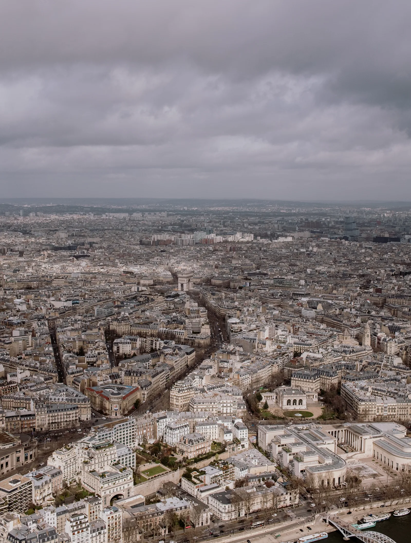 Paris rooftops and boulevards seen from above under a stormy sky