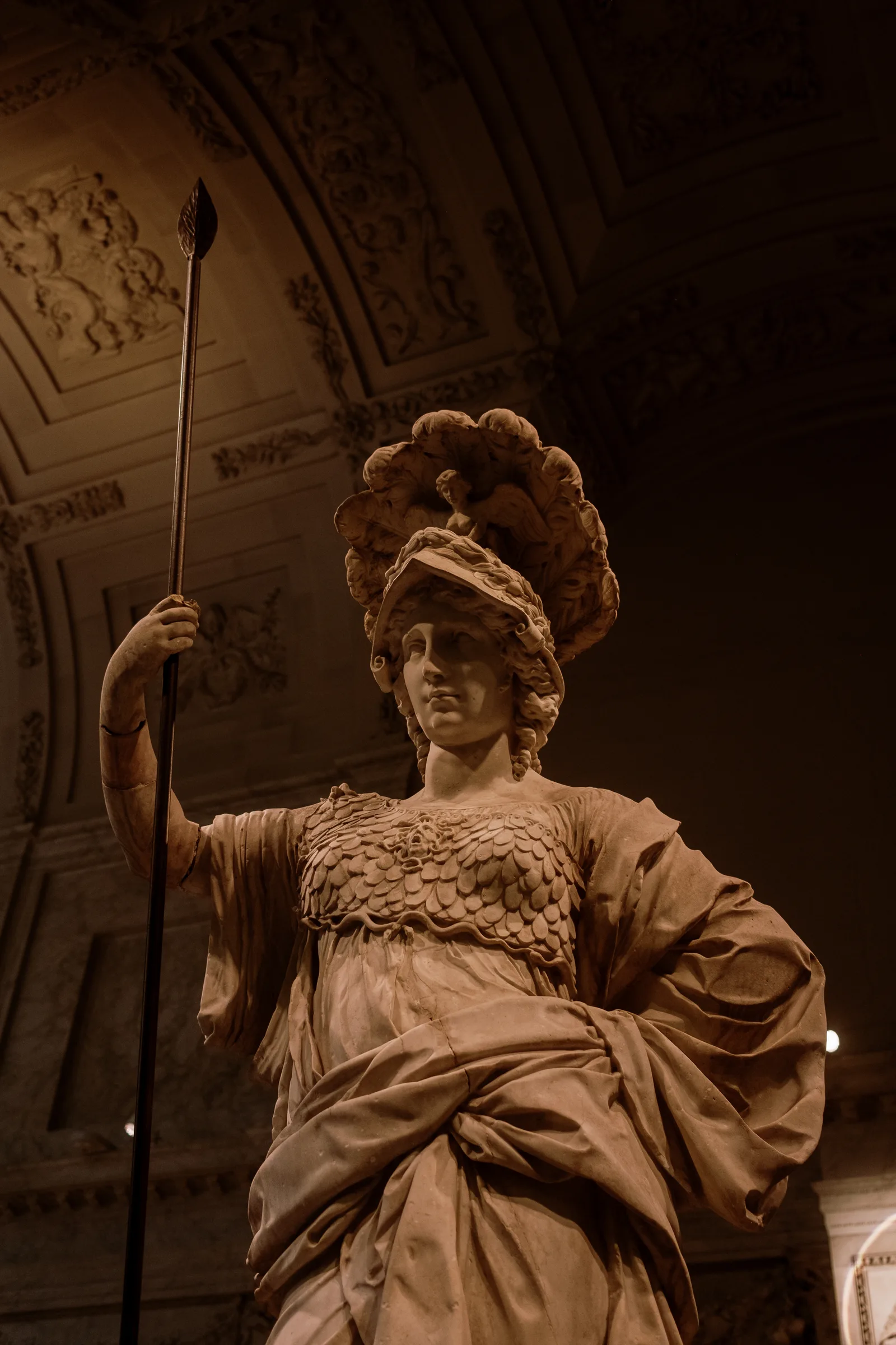 Marble statue of a helmeted figure holding a spear in a vaulted hall, Amsterdam