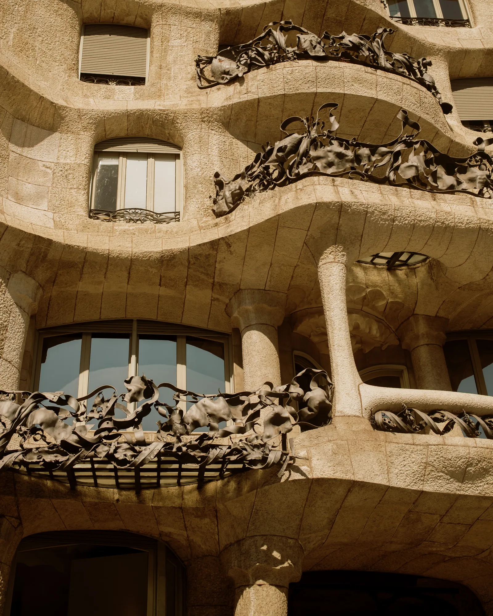 Casa Milà's wavy stone facade with sculpted wrought-iron balconies, Barcelona