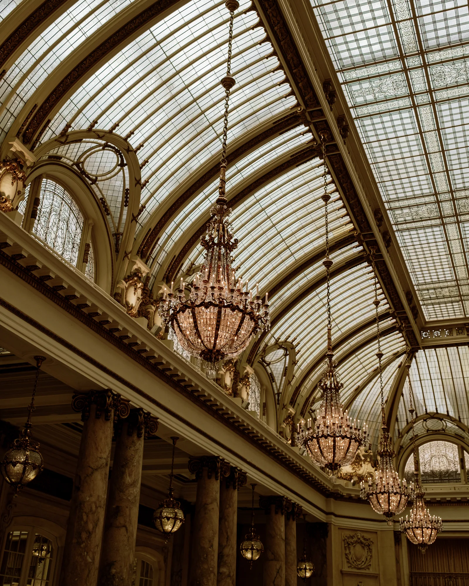 Chandeliers under a glass barrel-vault ceiling with gilded arches, San Francisco