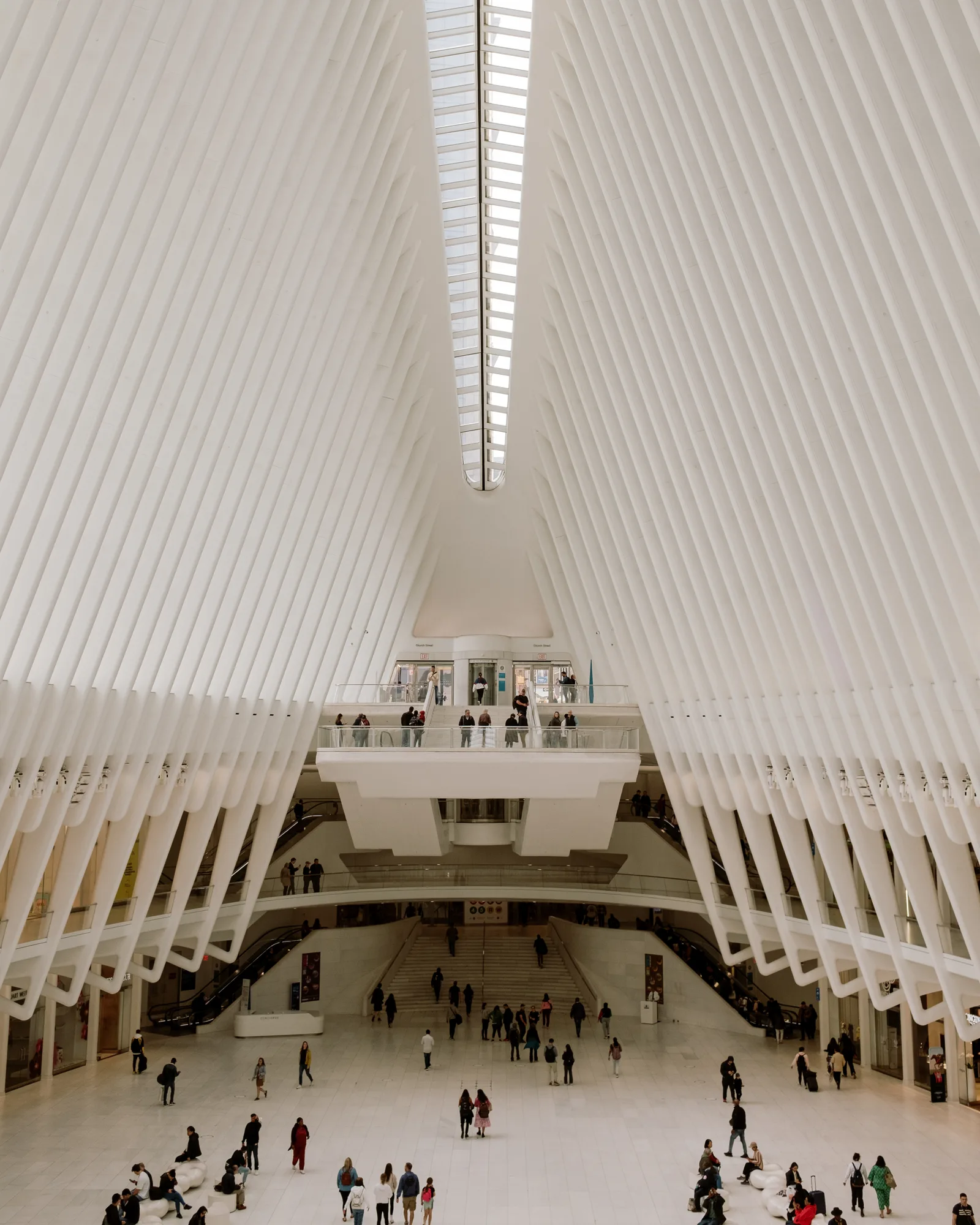 Interior of the Oculus with white ribs arching over crowds, New York