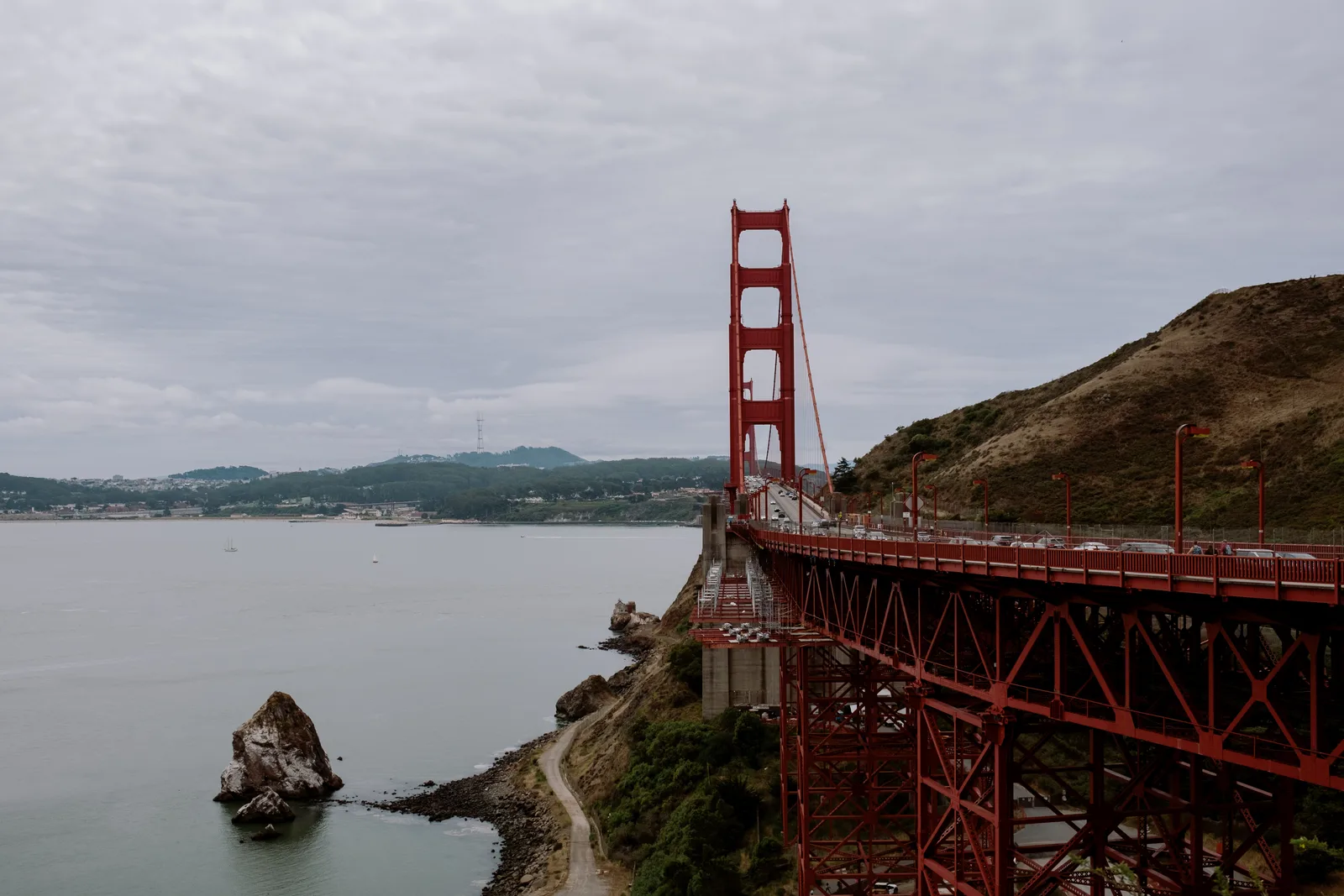 Golden Gate Bridge beyond a rocky headland and sea stack, San Francisco