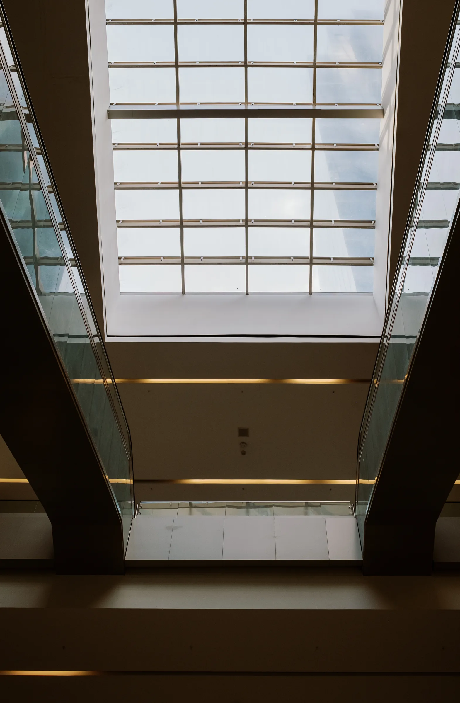 Looking up through a glass roof between two building walls, Panama City