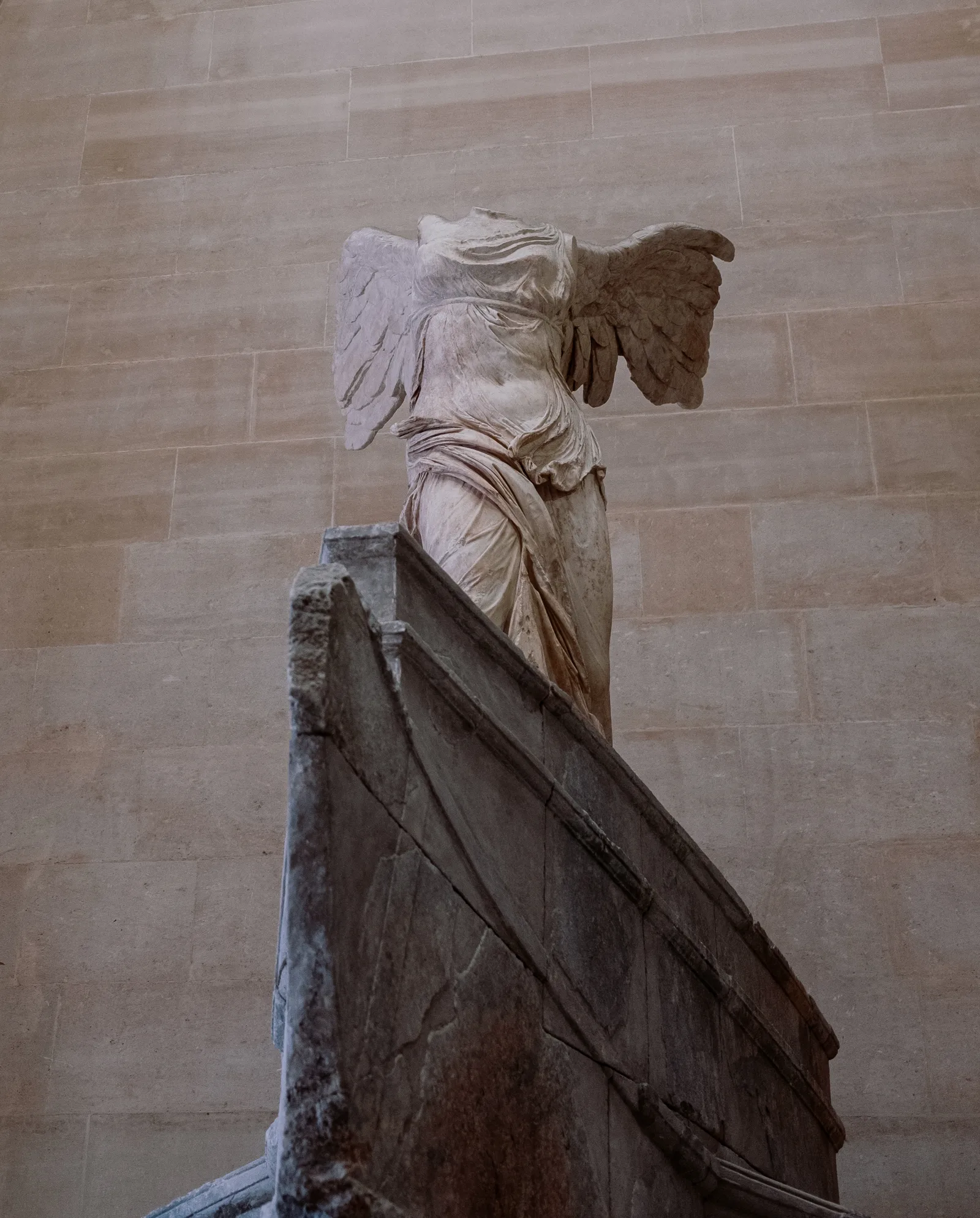 Winged Victory of Samothrace statue on its stone prow in the Louvre, Paris