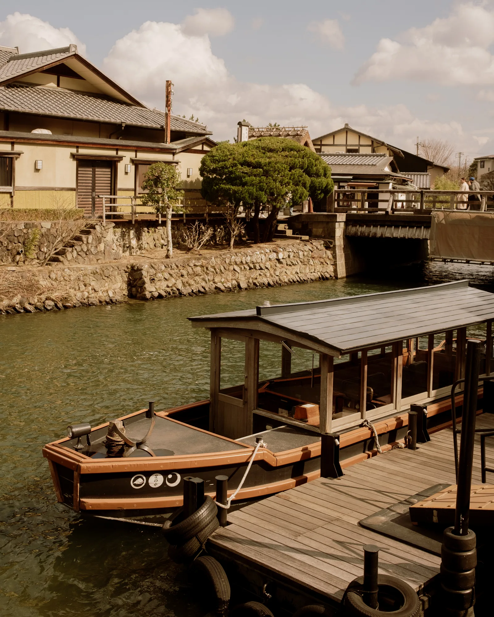 Traditional wooden boat moored at a dock on a Kyoto canal