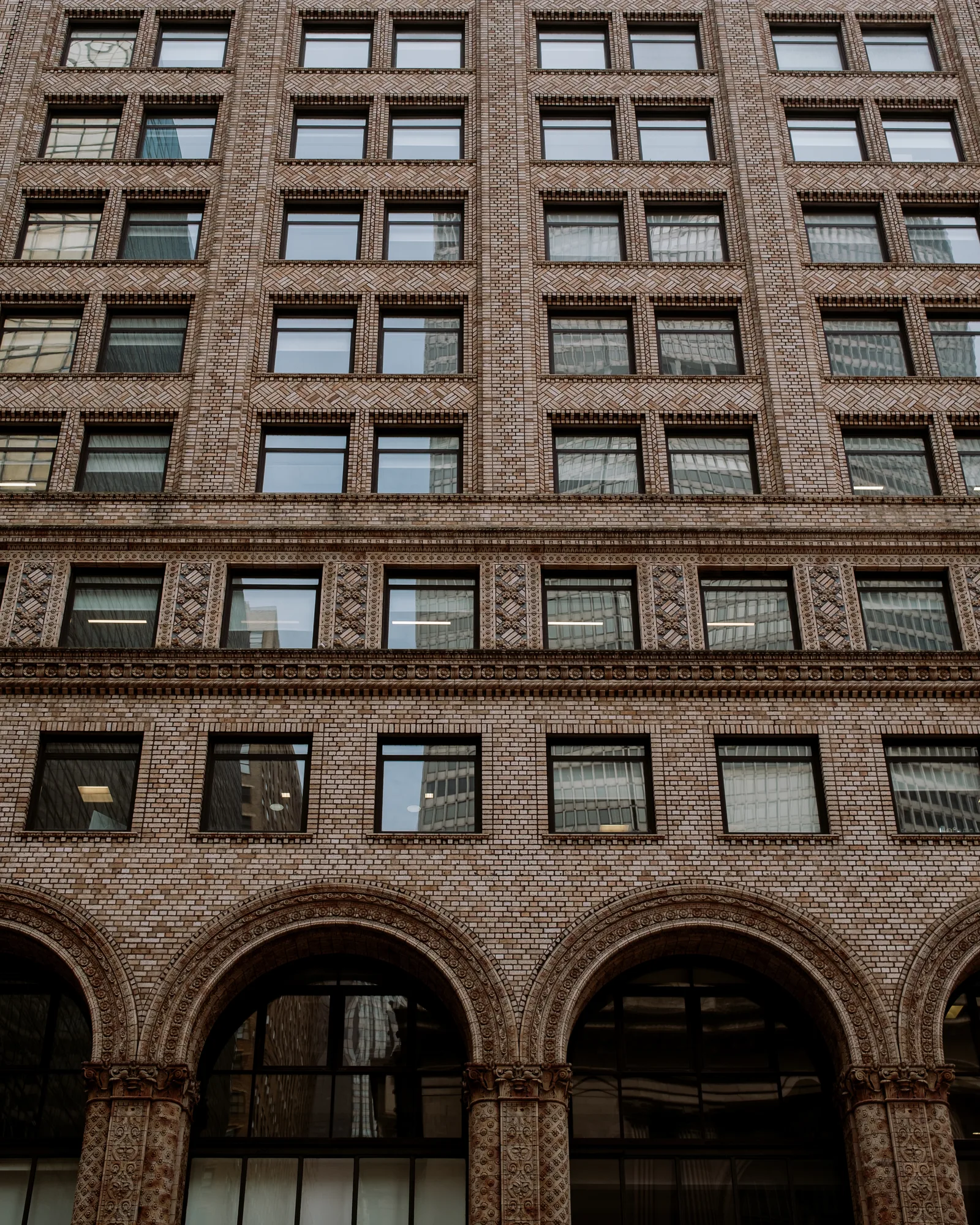Brick office building with arched ground-floor windows, New York