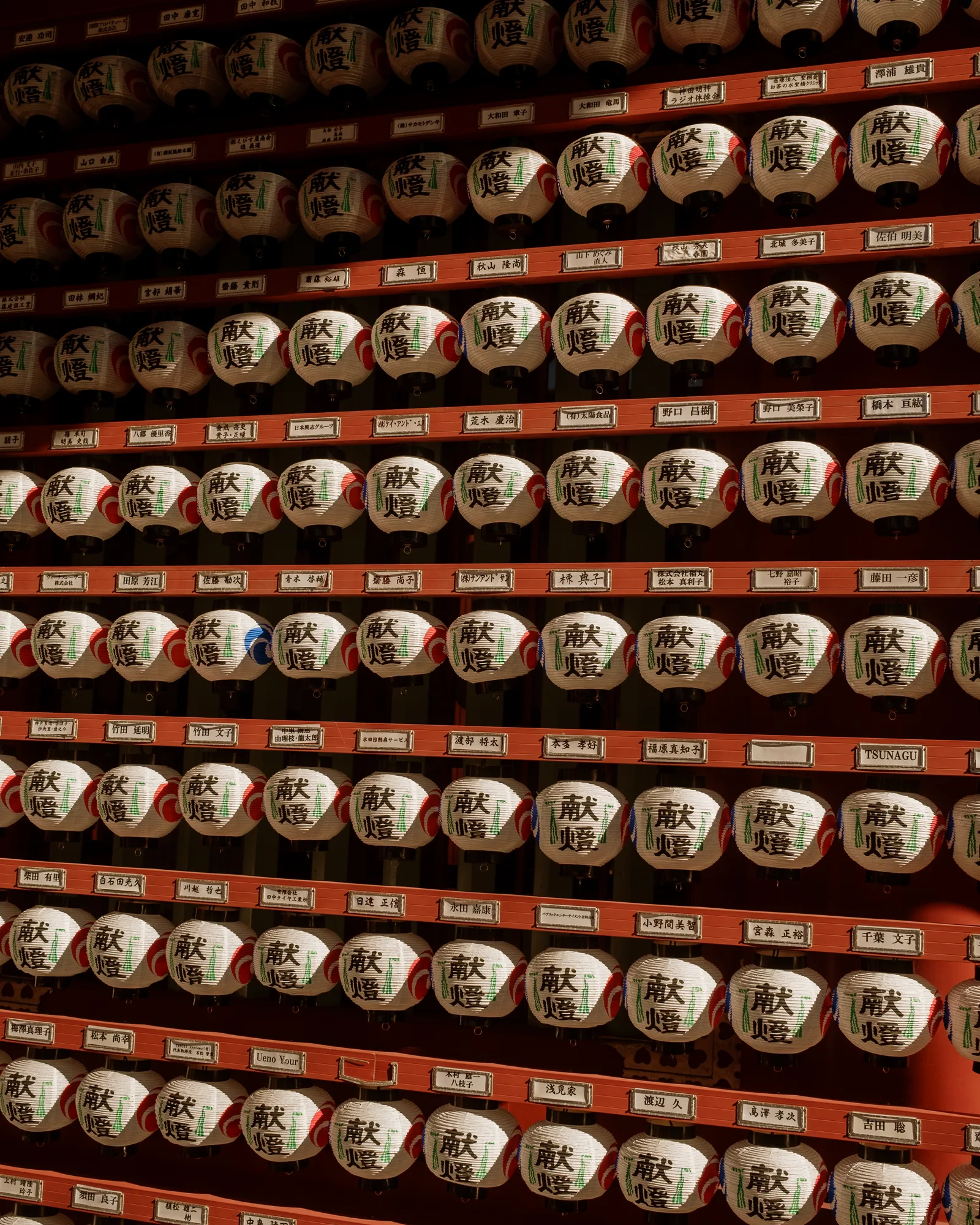 Shelves of small ceramic votive lanterns with painted kanji, Tokyo