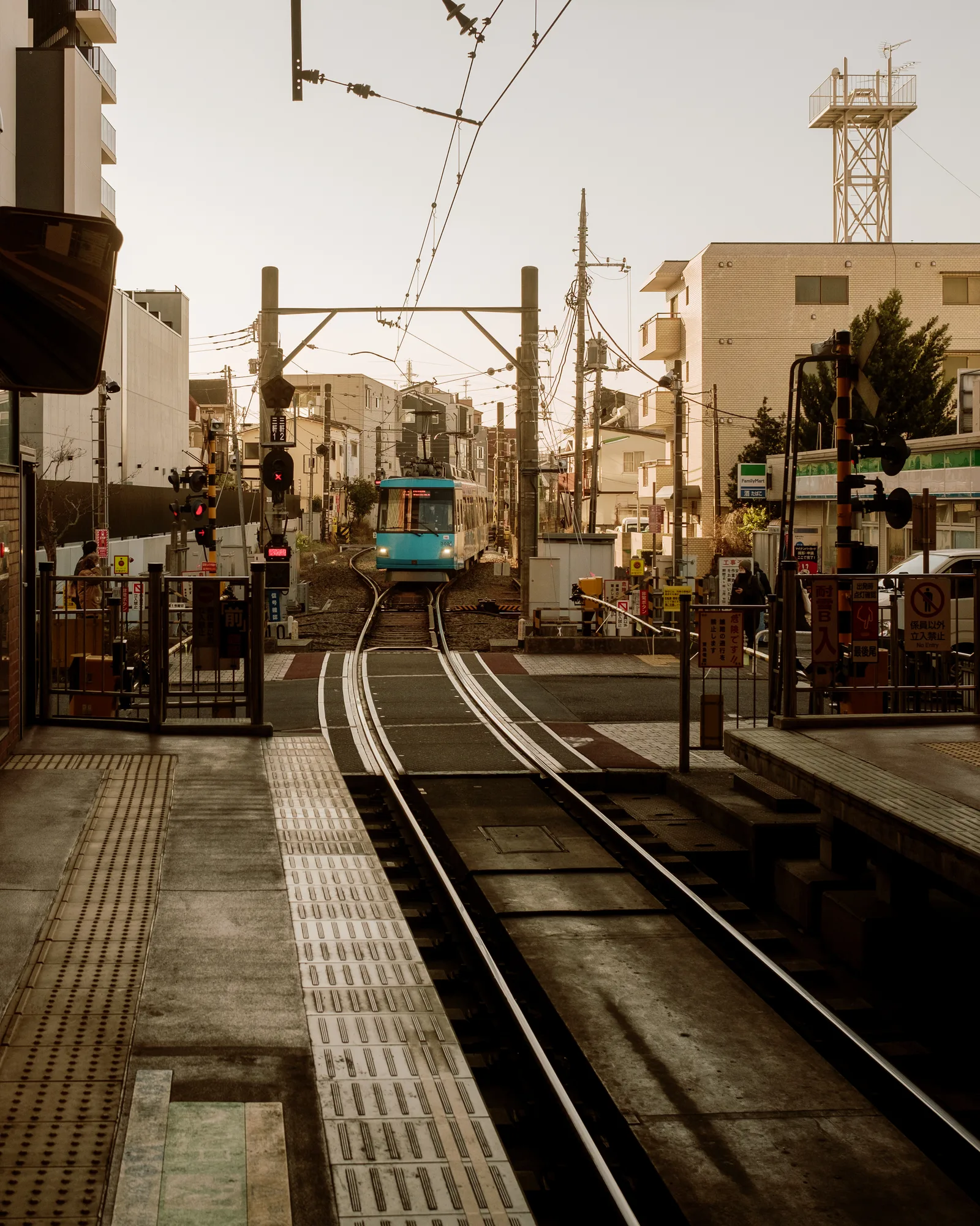 Tram arriving on a single-track line with a platform in the foreground, Tokyo