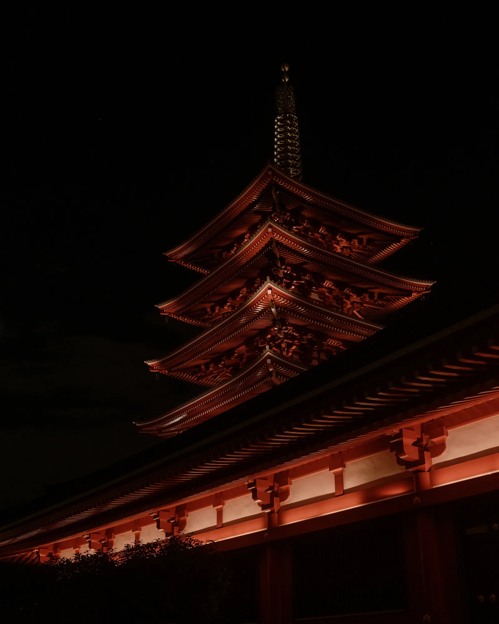 Red-lit five-storey pagoda against a black sky, Sensoji Temple, Tokyo