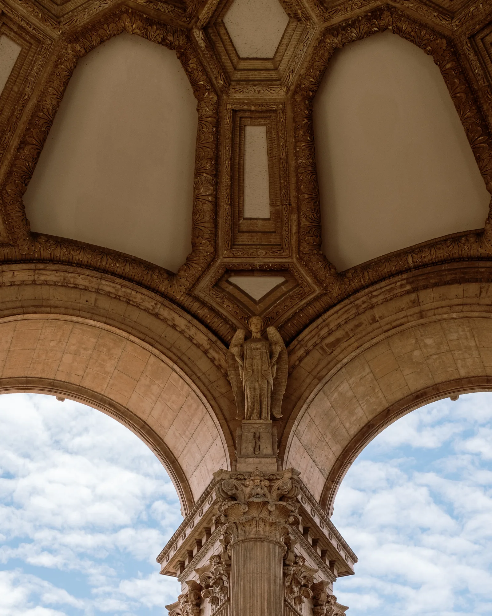 Coffered dome and arches of the Palace of Fine Arts framing blue sky, San Francisco