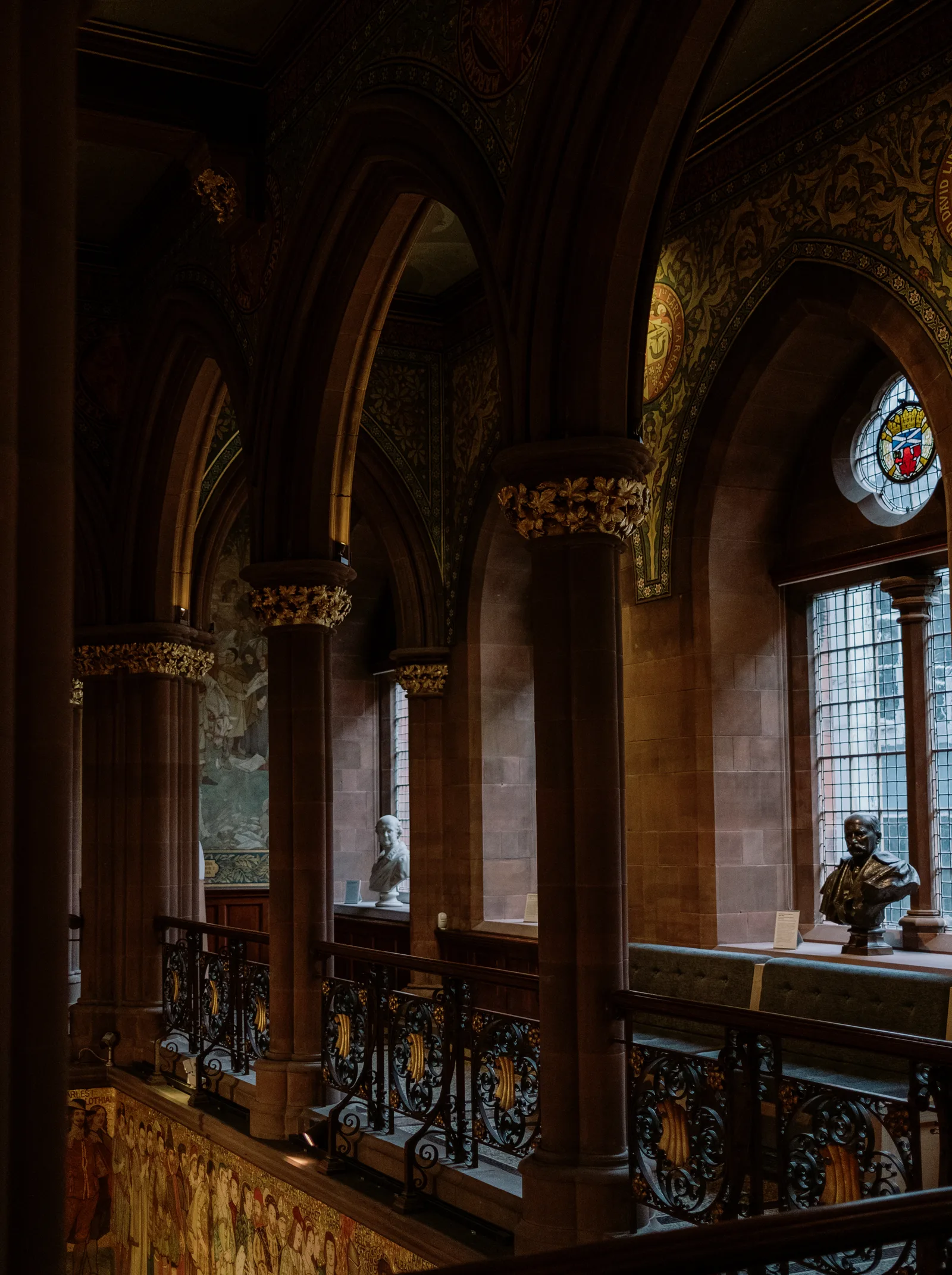 Gallery with carved arches, gilded capitals and iron balustrades in a Victorian Edinburgh building