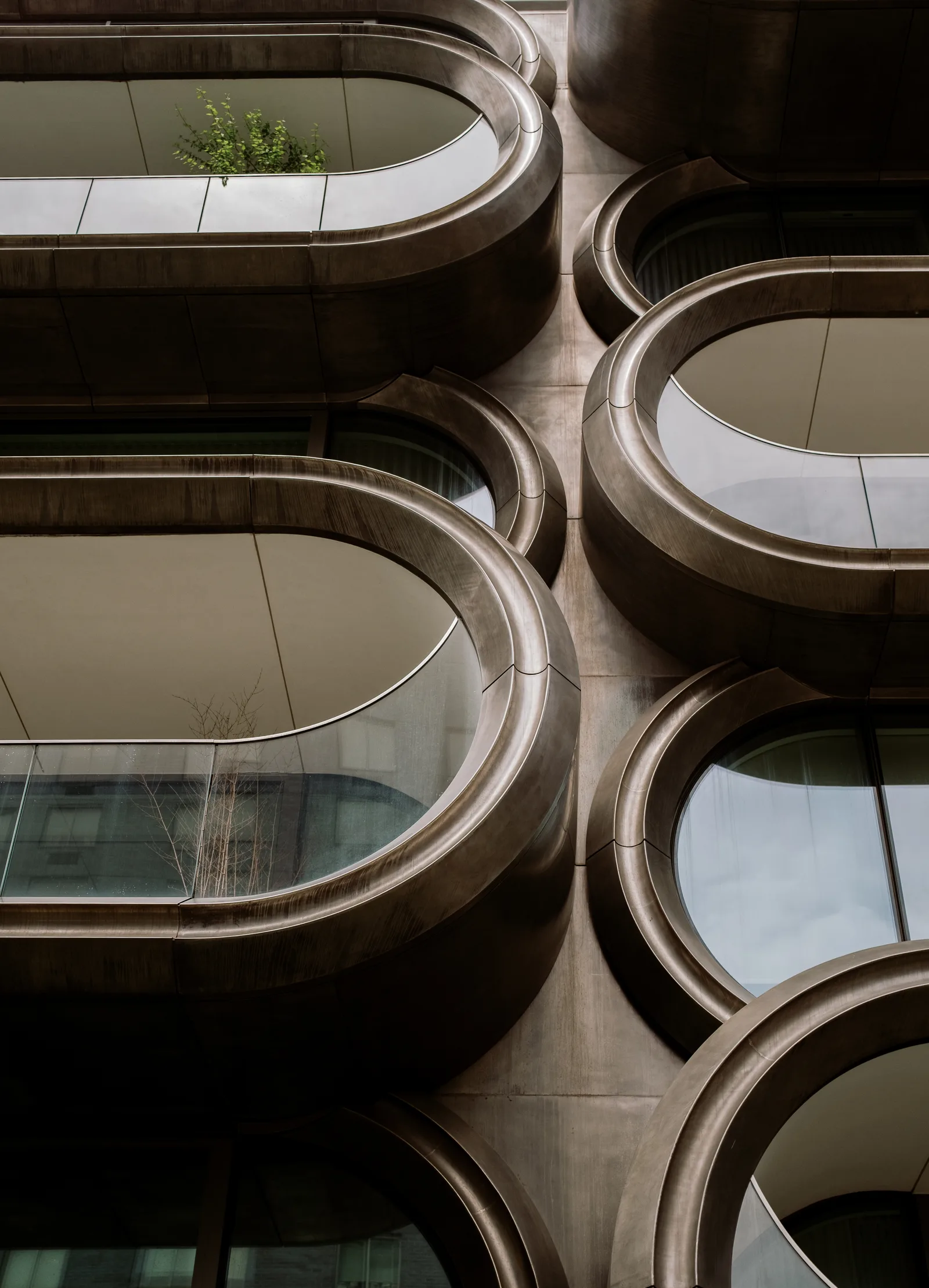 Rounded bronze balcony openings on a curving apartment facade, New York